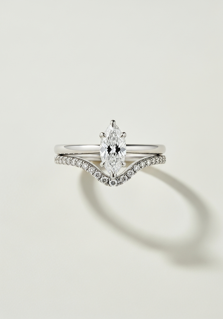 Curved contoured shadow platinum wedding band shaped to nest against the engagement ring, paired with a 2 carat VS1 marquise-cut lab-grown diamond solitaire