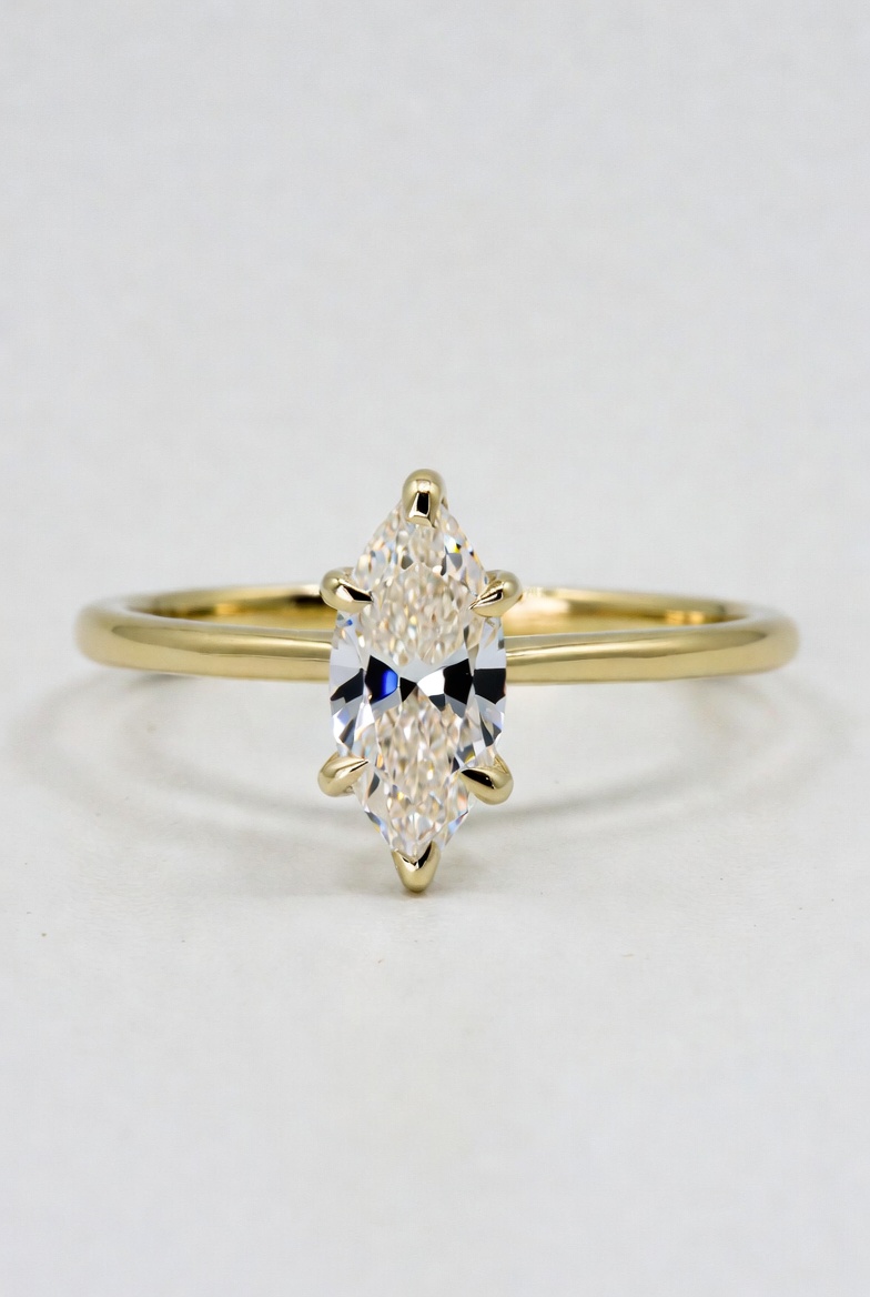 Marquise-cut lab-grown diamond solitaire with pointed ends held in a six-prong yellow gold setting