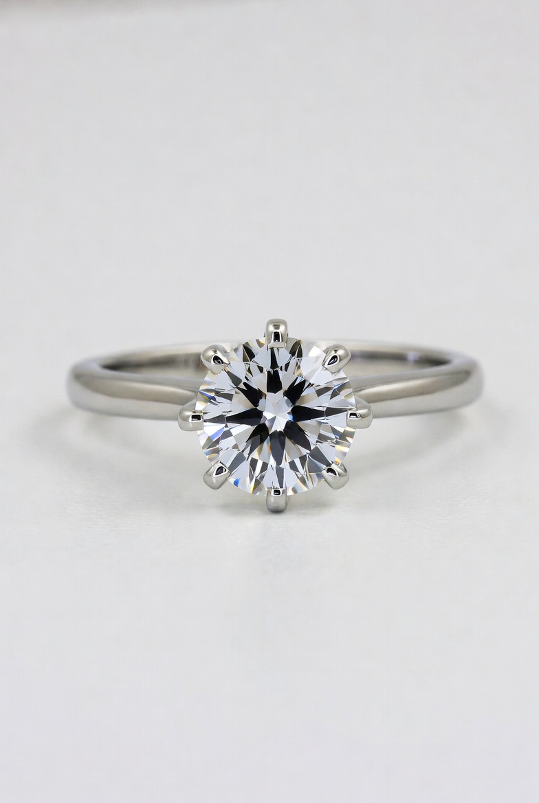 Round brilliant lab-grown diamond solitaire in a six-prong platinum setting on a slim polished band